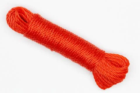 A coil of rope. Isolated. Large spool of red plastic cord on a white background Stock Photos