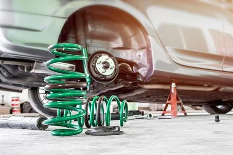 Coil spring and shock absorber on the service shop change and remove old pa.. Stock Photos
