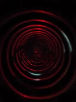 A coil spring with red ambient light. Stock Photos
