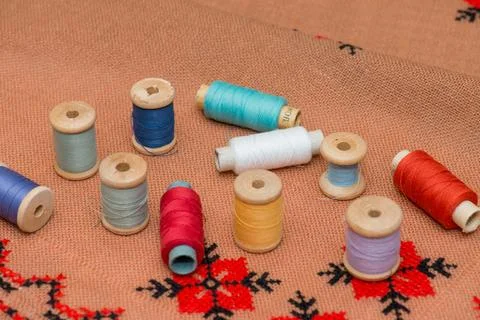 Coil thread on the canvas. Multicolored thread. Wooden coils. 写真素材