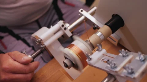 Coil winding machine reeling wire making electronic component - close up Stock-Footage 139514847