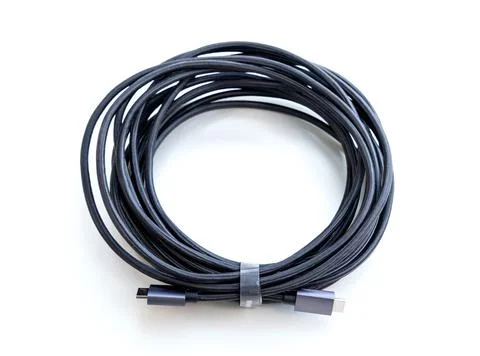 Coiled Black Braided Electronic Cable on White Background Stock-Fotos