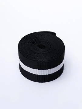 Coiled black webbing strap with white stripe Stock Photos
