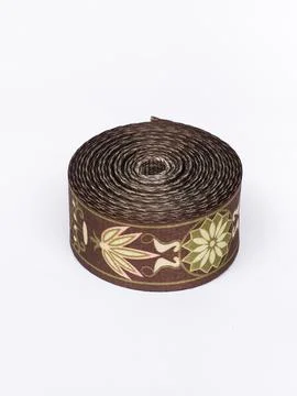 Coiled brown floral pattern trim ribbon Stock Photos
