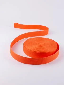Coiled orange webbing strap studio shot 스톡 사진