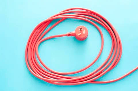 Coiled red electrical cable or lead with plug Stock Photos