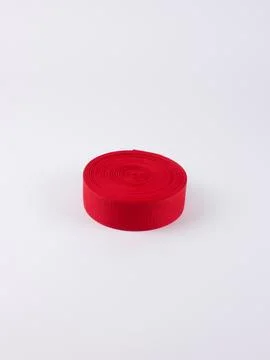 Coiled red webbing strap small studio shot Stock Photos