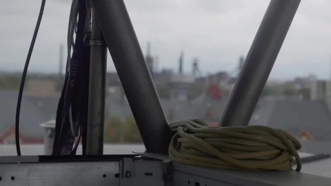 Coiled ropes on scaffold structure with city industrial skyline view Vídeos de archivo 319476531