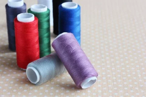 Coils of colored threads on the table. Stock Photos