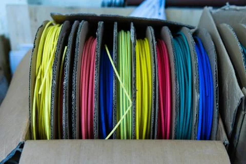 Coils with multi-colored electrical wires in the box Stock Photos