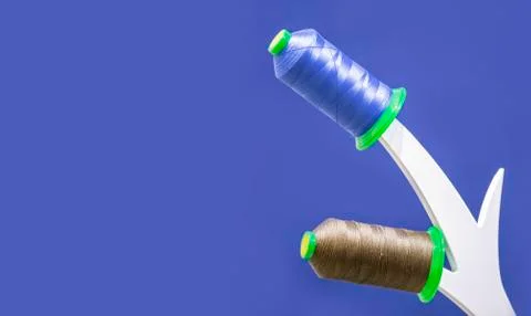Coils of thread, installation on a blue background, isolate. Stock Photos