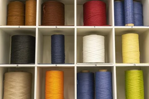 Coils with threads for hemming the edges of carpets Stock Photos