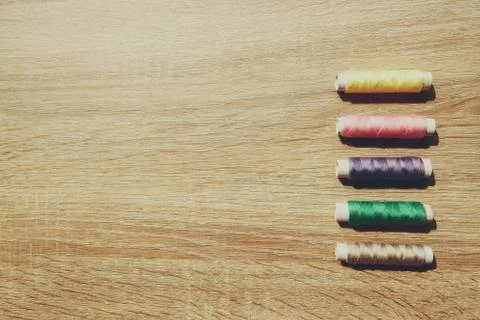The coils of threads put on wooden table Stock Photos