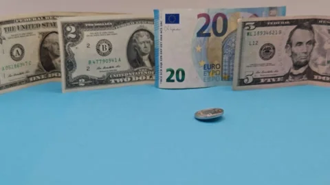 A coin against a background of banknotes Video stock 334957780