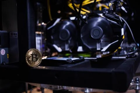 Coin bitcoin on the system unit Stock Photos
