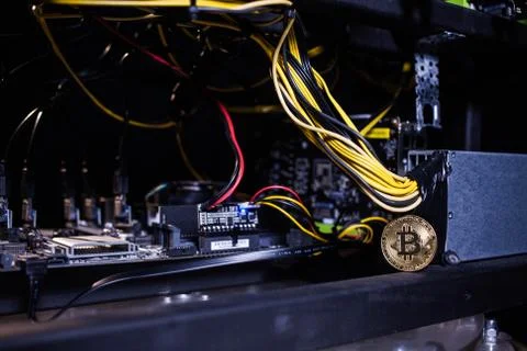 Coin bitcoin on the system unit Stock Photos