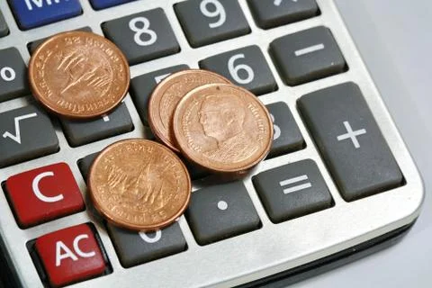 Coin on calculator Stock Photos