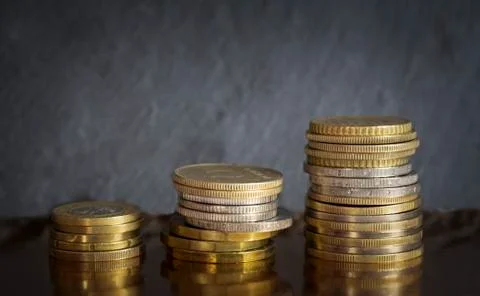 Coin columns on dark background Stock Photos
