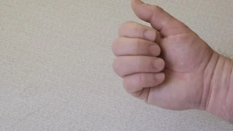 A coin is falling into an outstretched hand Stock Footage 306935080