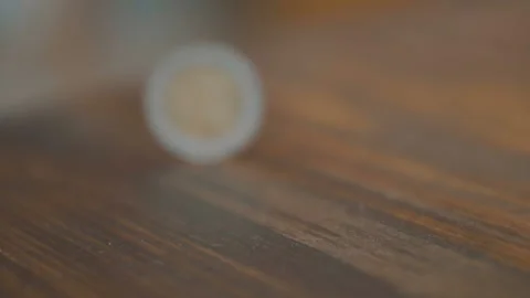 Coin Flip in Slow Motion with Alpha: A quarter flips through the air up from the Stock Footage 85976231