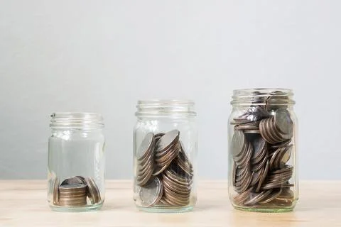 Coin in jar step growing up, Concept save money or investment financial Stock Photos