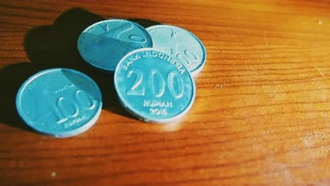 Coin money rolling in table Stock Footage 219958319