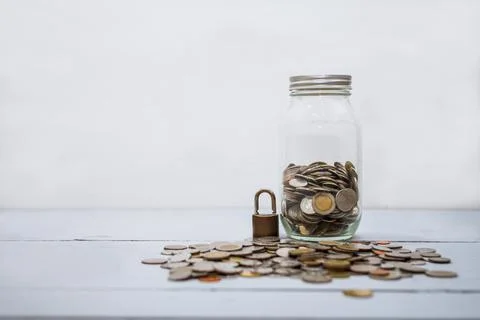 Coin money stack and lock with space for text background. Saving and financia Stock Photos