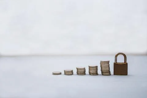 Coin money stack and lock with space for text background. Saving and financia Stock Photos