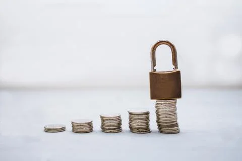 Coin money stack and lock with space for text background. Saving and financia Stock Photos