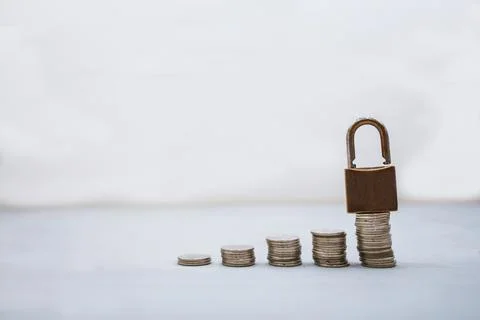 Coin money stack and lock with space for text background. Saving and financia Stock Photos