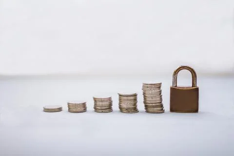 Coin money stack and lock with space for text background. Saving and financia Stock Photos