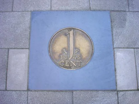 Coin of one cent in pavement Stock Photos