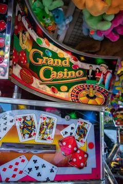 Coin pusher machine featuring a deck of cards Stock Photos