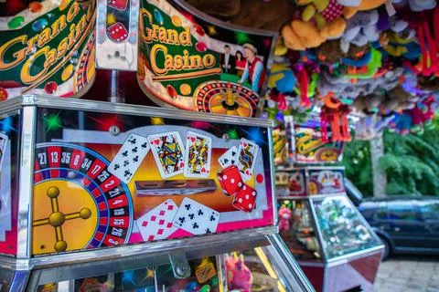 Coin pusher machine featuring a deck of cards Stock Photos