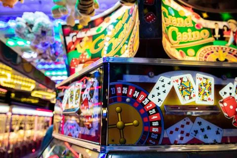 Coin pusher machine featuring a deck of cards Stock Photos