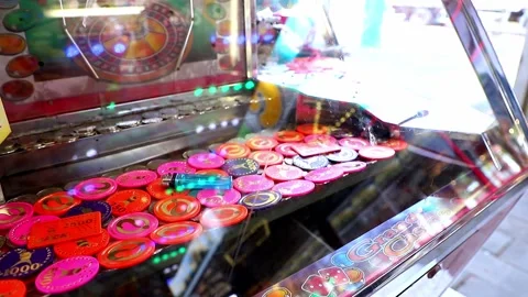 Coin pusher machine with a lot of coins Stock Footage 197337980