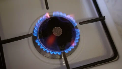 Coin, russian ruble in burning gas on the stove in the dark. Concept Stock Footage 220000006