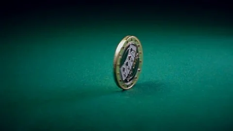 Coin Spinning on a Game Table Stock Footage 70637676