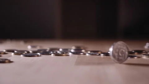 The coin is spinning on the table among the coins Video stock 152418968