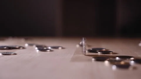 The coin is spinning on the table among the coins Stock-Footage 152419043