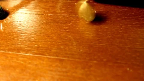 Coin spinning on a table in the shade Stock Footage 73836767