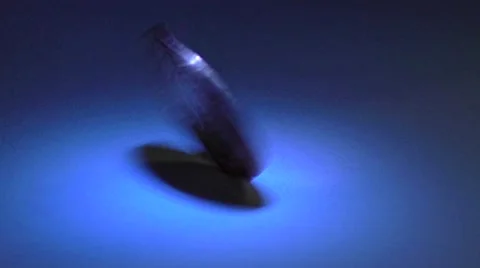 Coin spinning under a spot light Stock Footage 44399703