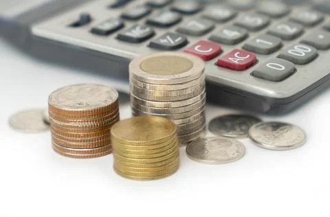 Coin stack with calculator on isolate white background Foto stock