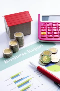 Coin stack with red house and calculator and pen on business report backgro.. Stock Photos