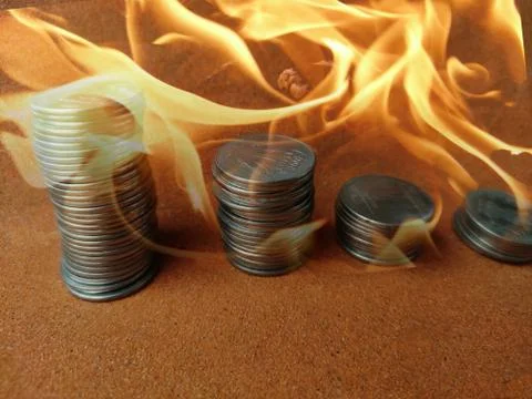 Coin stack step down graph in fire ,Stock market fall, Risk management. Money Foto stock