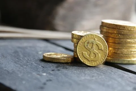 Coin stacks on a gray background. Stock Photos