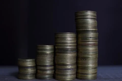 Coin stacks  - stacking money as concept for success or savings, investment a Stock Photos