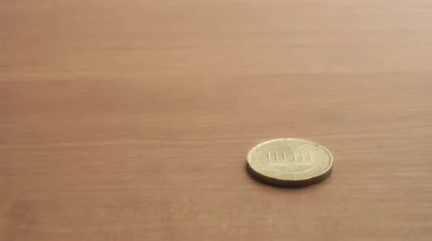 Coin on the table rotates slowly Stock Footage 39583011