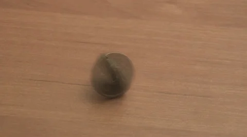 Coin on the table rotates slowly Stock Footage 39583044