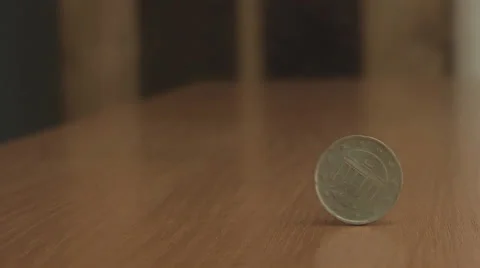 Coin on the table rotates slowly Stock Footage 39583188
